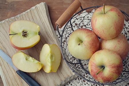 red slice of apples beside black knife thumbnail