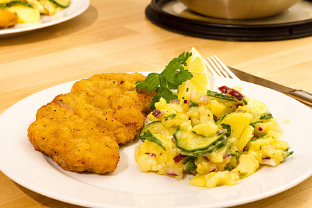 fried meat beside vegetable on ceramic plate thumbnail