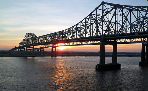 black suspension bridge during sunset thumbnail