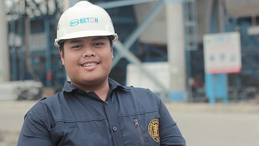 man wearing white hard hat smilling thumbnail