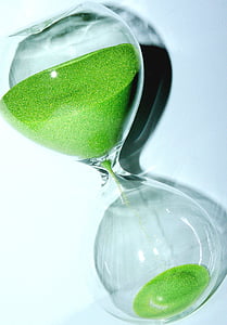 clear and green hourglass on white surface thumbnail