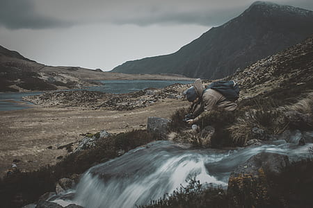 man taking photo of river thumbnail