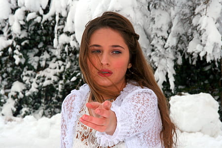 woman wearing white lace top standing snow covered tree at daytime thumbnail