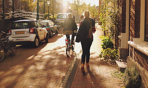 person riding on bike near cars thumbnail