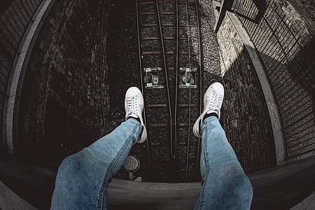 Person in Blue Denim Stonewashed Fitted Jeans and White Low-top Sneakers thumbnail