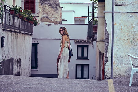 woman standing on village pathway thumbnail