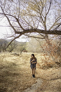 woman standing in forest thumbnail