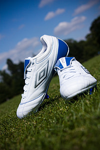 selective focus photography of white-and-blue Umbro cleats thumbnail