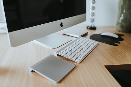 White Apple iMac computer with elephant mousepad thumbnail