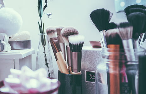 close up photo of assorted-color makeup brushes on jar thumbnail