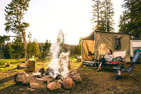 woman sitting on camping chair in front of bonfire thumbnail
