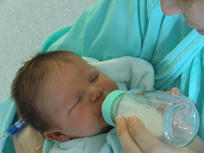 woman feeding baby using feeding bottle thumbnail