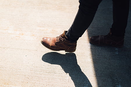 person wearing brown leather dress boots walking thumbnail