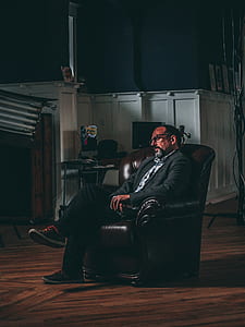 man in gray jacket sitting on sofa chair thumbnail