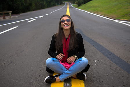 Woman Sitting on Middle of the Road thumbnail