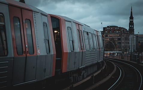 gray and orange train on rails thumbnail