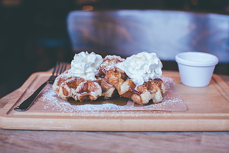 bread with white icings on brown wooden board thumbnail