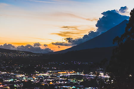 high angle photo of buildings with background of mountain thumbnail
