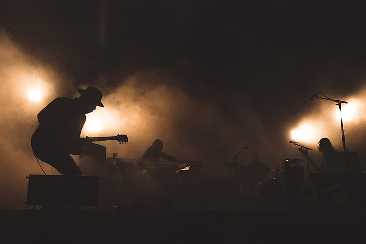 silhouette of band with smokes