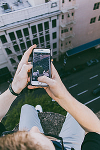person holding silver iPhone 6 on top of building taking photo thumbnail