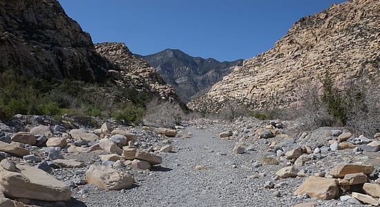 beige stones near cliff under blue sky during daytime thumbnail