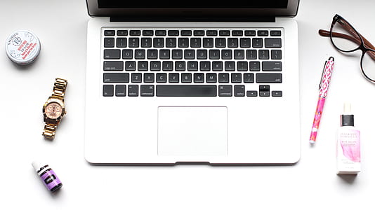MacBook Pro near round gold-colored watch thumbnail