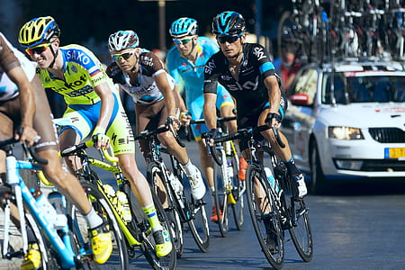 group of men riding bicycles on the road thumbnail