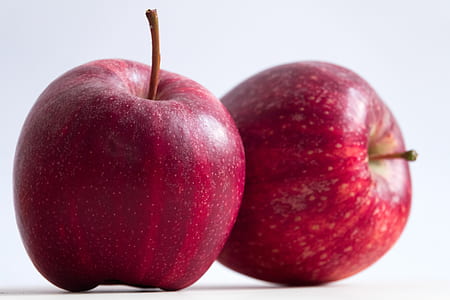 two red apple fruits on white surface thumbnail