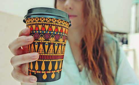 woman holding black and yellow container with lid thumbnail