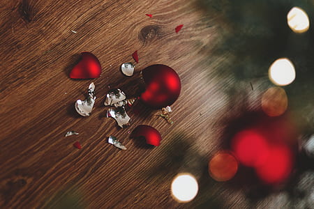 selective focus photo of broken Christmas bauble on the the floor thumbnail