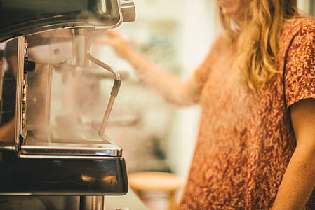 woman standing near espresso maker thumbnail
