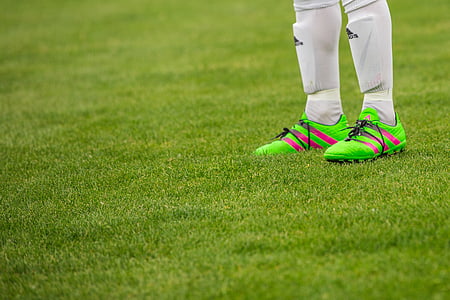 selective focus photography of green cleats thumbnail