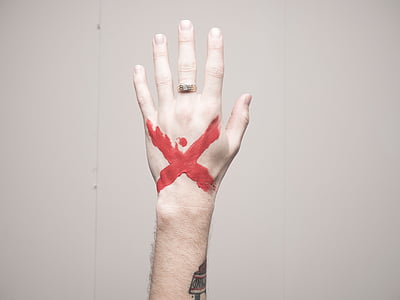 leftperson's hand with red x tattoo thumbnail