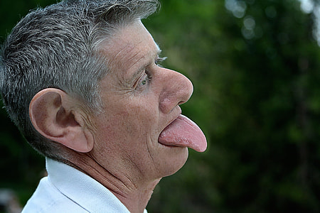 man sticking tongue out at daytime thumbnail