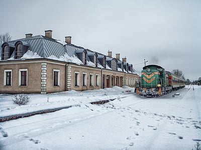 green and brown train near concrete house at daytime thumbnail