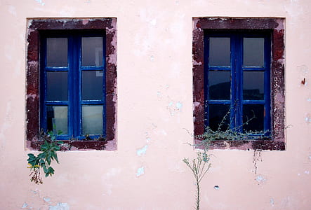 white painted house with blue wooden windowpanes thumbnail