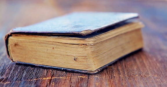 selective focus photography of black book on brown surface thumbnail