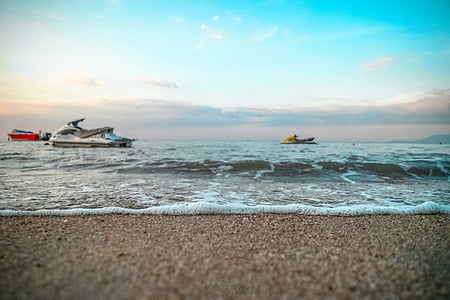 two yellow and white personal watercrafts under blue sky on body of water thumbnail