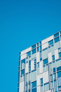 blue and white building under blue sky thumbnail