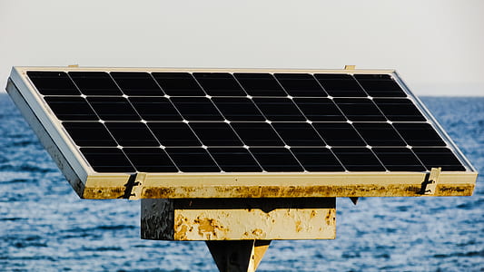 black solar panel on gray metal surrounded by watre thumbnail