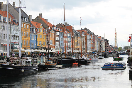 sailboats parked beside buildings at daytime thumbnail