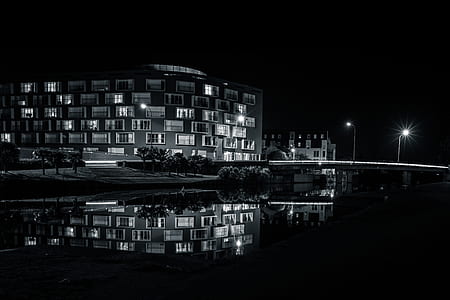 grayscale photography of body of water near building thumbnail