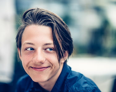 selective focus photo of man wearing blue collared shirt while smiling thumbnail