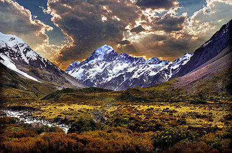 snow covered mountains under black and grey cloudy sky thumbnail
