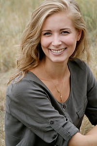 smiling woman wearing gray shirt thumbnail