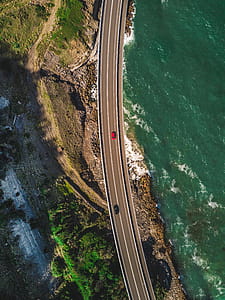 Two Vehicle on Pathway Beside Body of Water thumbnail