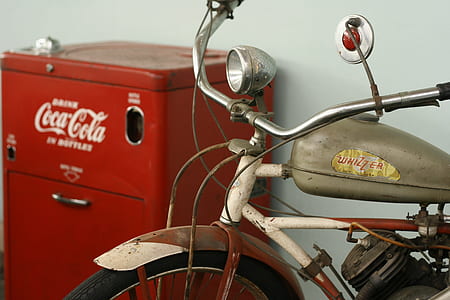 gray motorcycle beside red Coca-Cola cabinet thumbnail