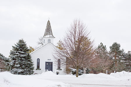 landscape photography of building covered with snow near leafless tree thumbnail