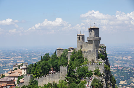 gray castle on under blue sky and white clouds thumbnail