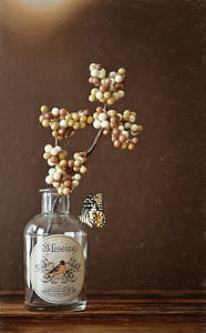 white and brown berries on clear glass bottle thumbnail